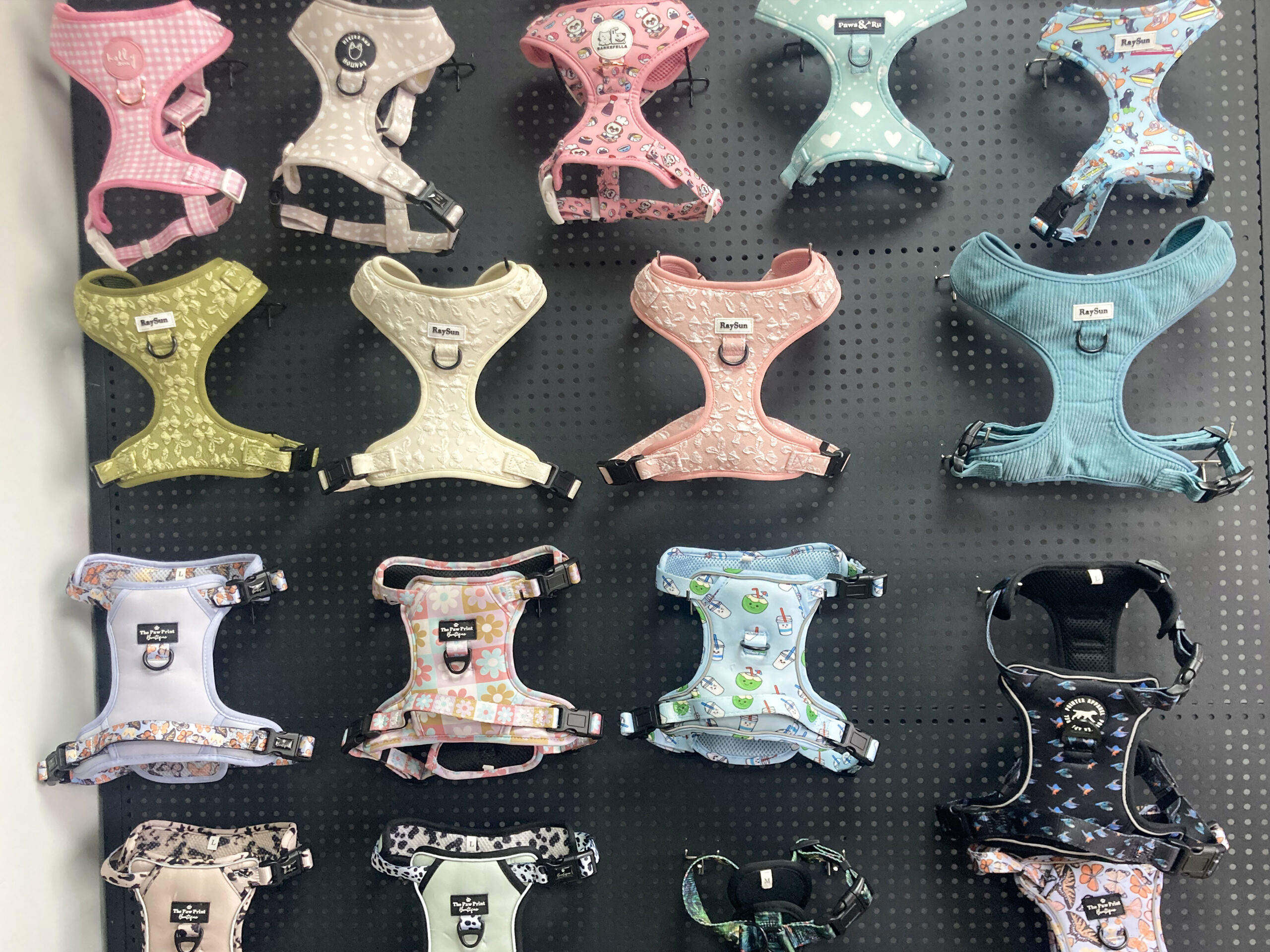 A collection of different wholesale dog harnesses on display